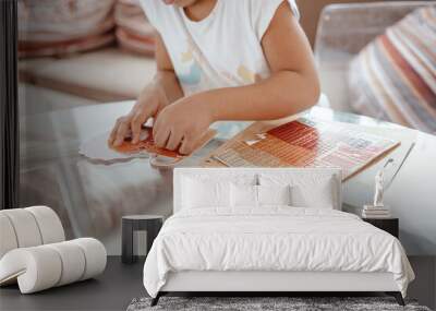 Close up of cute little girl`s hands playing with a puzzle, child development concept. Wall mural